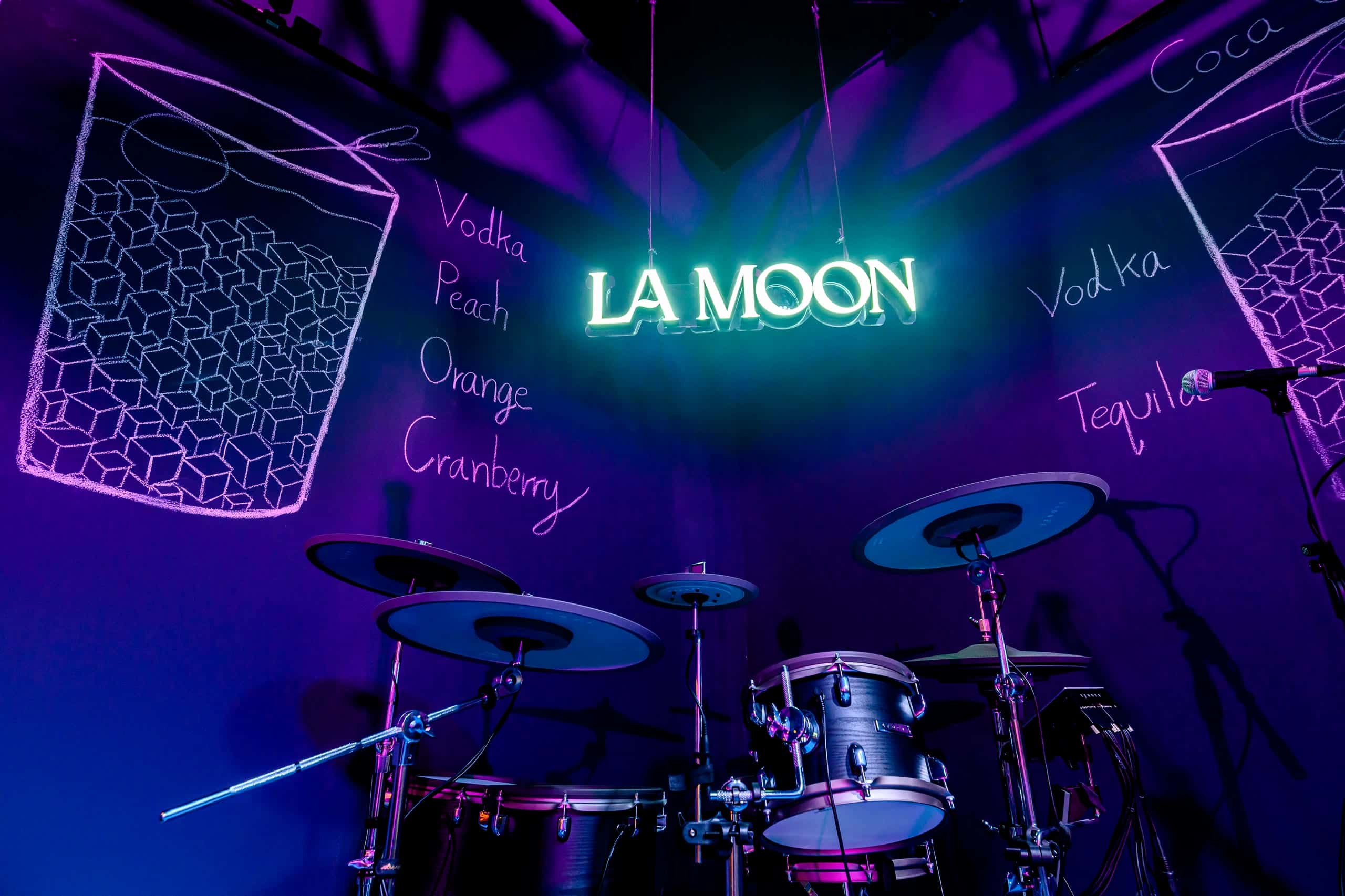 The hand drawn cocktail wall at La Moon, a giant glass outlined in chalk with its ingredients written beside it